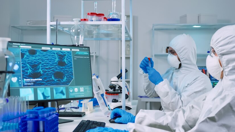 chemist-doctor-ppe-suit-working-pc-while-lab-technician-using-microscope-team-scientists-examining-vaccine-evolution-with-high-tech-researching-treatment-against-covid19-virus_482257-3814